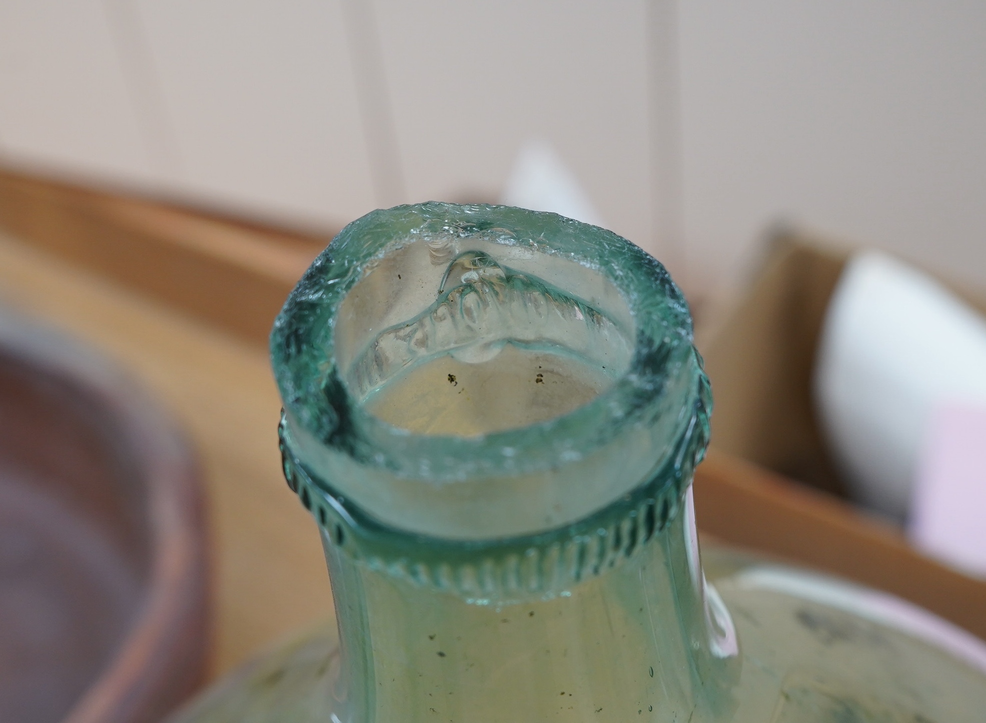 A large glass globular bottle, 48cm high. Condition - poor, significant staining and chipping to rim.